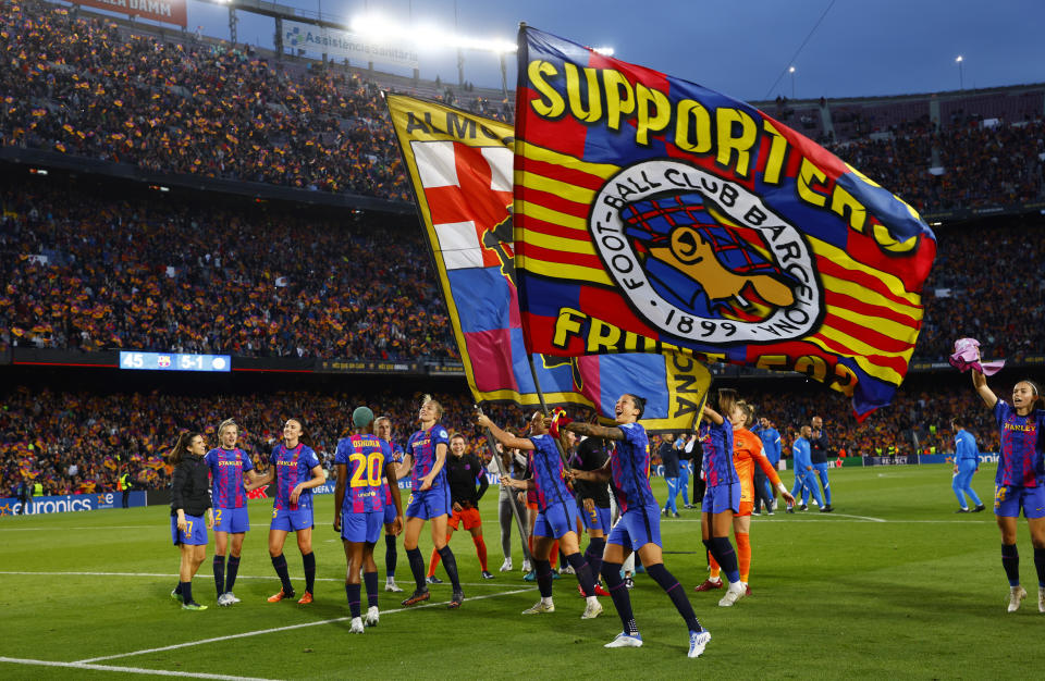 Barcelona players celebrate after winning the Women's Champions League semifinal, first leg, soccer match between Barcelona and Wolfsburg at Camp Nou stadium in Barcelona, Spain, Friday, April 22, 2022. (AP Photo/Joan Monfort)