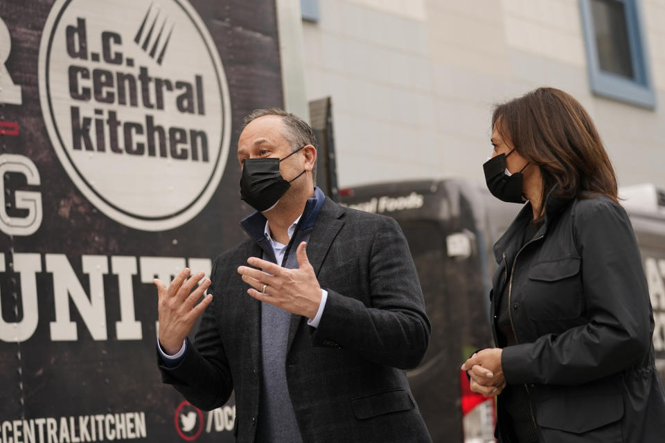 Vice President-elect Kamala Harris listens as her husband Doug Emhoff speaks during a visit to DC Central Kitchen, Wednesday, Nov. 25, 2020, in Washington. (AP Photo/Andrew Harnik)