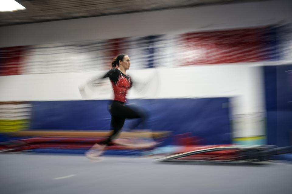 Former world champion and Olympic silver medalist Chellsie Memmel works out Thursday, Feb. 18, 2021, in New Berlin, Wisc. Memmel, 32, is attempting to return to competition following a nearly decade-long break. (AP Photo/Morry Gash)