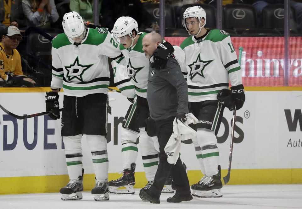 Dallas Stars center Mattias Janmark (13), of Sweden, is helped off the ice after being injured during the second period in Game 2 of an NHL hockey first-round playoff series against the Nashville Predators, Saturday, April 13, 2019, in Nashville, Tenn. (AP Photo/Mark Humphrey)