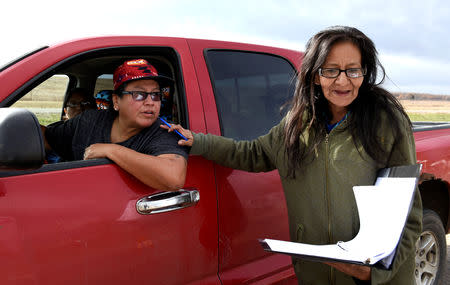 Brenda Miller (R) speaks to a voter while canvassing voters in Porcupine, North Dakota ahead of the 2018 mid-term elections on the Standing Rock Reservation, U.S. October 26, 2018. REUTERS/Dan Koeck