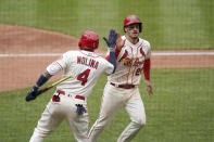 St. Louis Cardinals' Nolan Arenado, right, is congratulated by teammate Yadier Molina (4) after scoring during the fifth inning of a baseball game against the Colorado Rockies Saturday, May 8, 2021, in St. Louis. (AP Photo/Jeff Roberson)