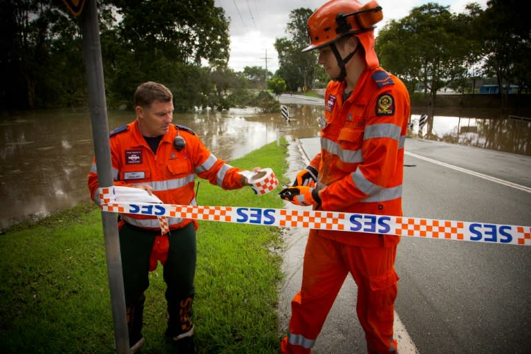 A State Emergency Service crew close off a flooded road in Beenleigh, noertheast Australia on March 31, 2017