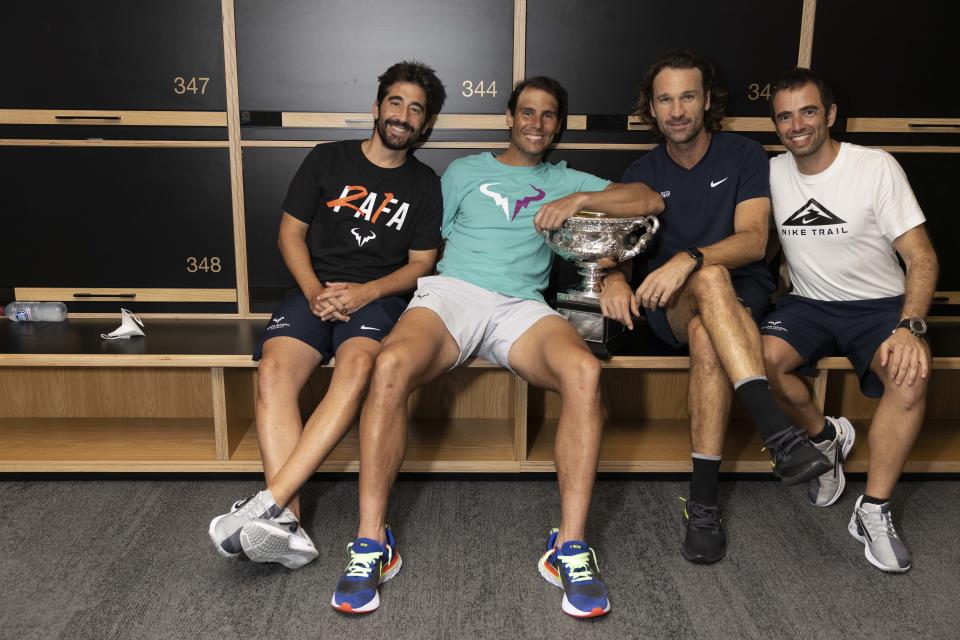 Rafael Nadal, pictured here with the Australian Open trophy and his coaching team in the locker room.