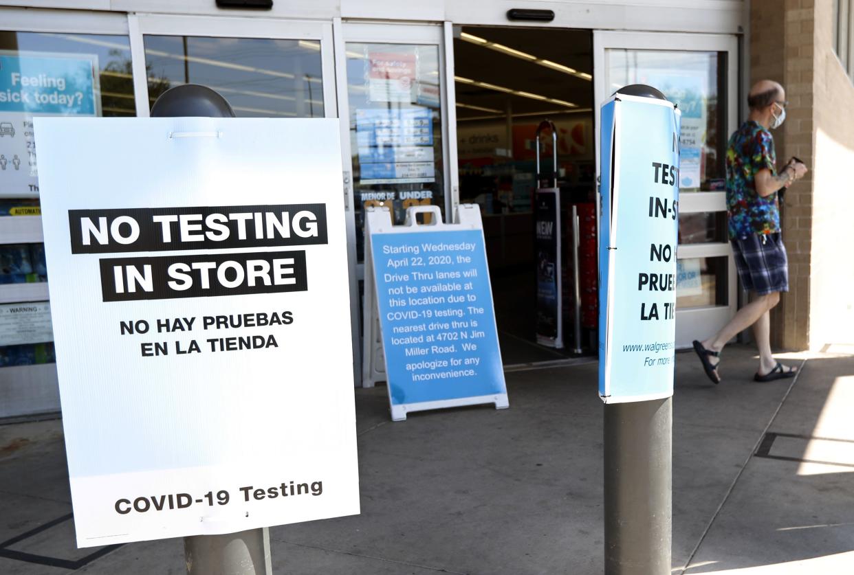 Signs outside of a Walgreens advises that no COVID-19 testing is done inside the store as a customer departs the location in Dallas, Texas on Saturday, April 25, 2020. This location began testing for the new coronavirus the day before with a drive-thru process and is provided to eligible individuals at no cost. Persons wanting to be tested are asked to go online to their website to determine their eligibility. The test is self-administered with directions from store pharmacists.