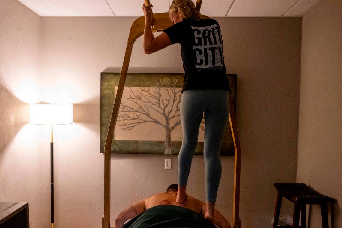 Courtney Letcher gives an Ashiatsu massage to a client at Grit City Wellness on Friday, July 22, 2022, in Tacoma, Wash.