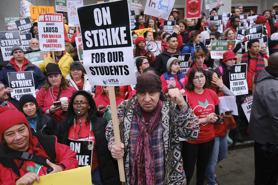 Actor, musician and activist, Steven Van Zandt, center, supports striking teachers on the picket in front of Hamilton High School in Los Angeles on Wednesday, Jan. 16, 2019. School administrators urged the union to resume bargaining as tens of thousands of teachers planned to walk picket lines for a third day Wednesday. (AP Photo/Richard Vogel)