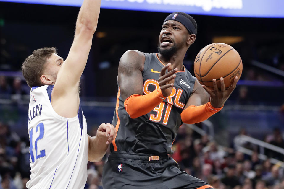 Orlando Magic guard Terrence Ross (31) attempts to shoot against Dallas Mavericks forward Maxi Kleber during the second half of an NBA basketball game, Friday, Feb. 21, 2020, in Orlando, Fla. (AP Photo/John Raoux)