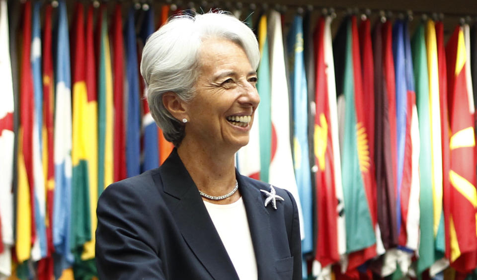 Former French Finance Minister Christine Lagarde smiles as she arrives at the International Monetary Fund headquarters for her first day as head of the IMF in Washington July 5, 2011.     REUTERS/Kevin Lamarque  (UNITED STATES - Tags: BUSINESS HEADSHOT POLITICS)