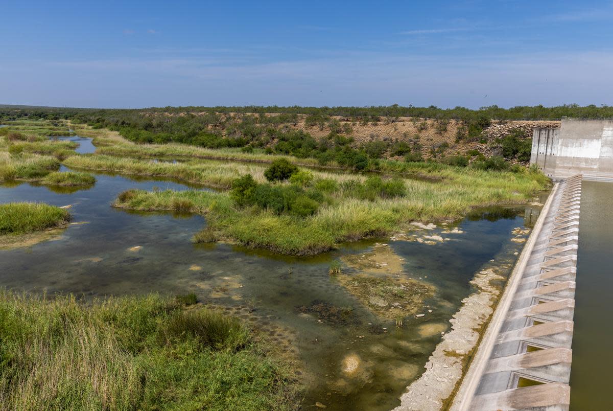 Stagnant water is seen at the dry spillway of the Falcon Dam in Starr County on Aug. 18, 2022. Assistant Area Operations Manager at the Falcon dam Jesus Guerra says water has not flowed through the spillway since last year because water levels are below the dam gates.