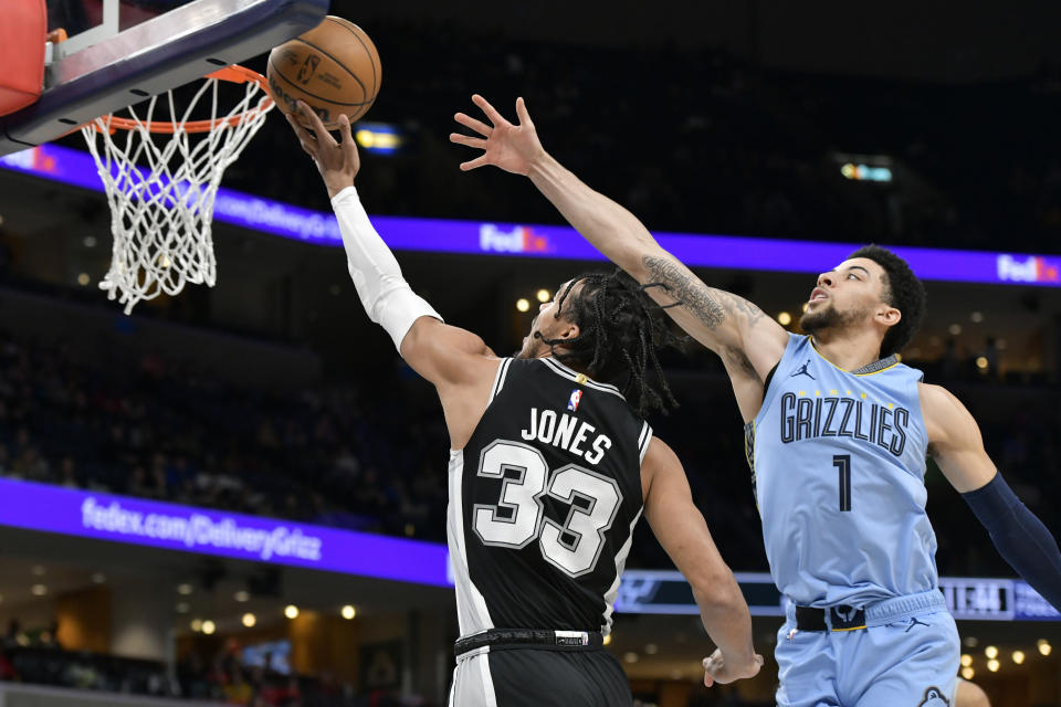 San Antonio Spurs guard Tre Jones (33) shoots ahead of Memphis Grizzlies guard Scotty Pippen Jr. (1) in the first half of an NBA basketball game Tuesday, April 9, 2024, in Memphis, Tenn. (AP Photo/Brandon Dill)