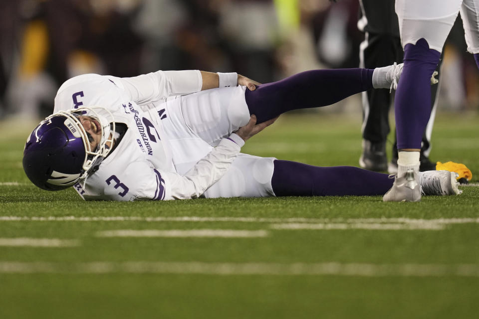 Northwestern quarterback Ryan Hilinski (3) stays on the ground after sustaining an injury against Minnesota during the second half of an NCAA college football game Saturday, Nov. 12, 2022, in Minneapolis. (AP Photo/Abbie Parr)