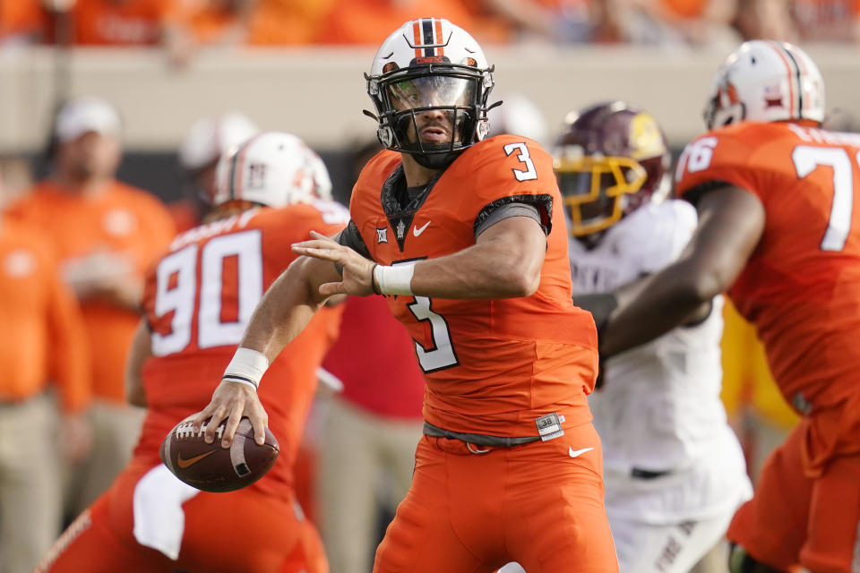 Oklahoma State quarterback Spencer Sanders (3) looks for a receiver during the first half of the team's NCAA college football game against Central Michigan, Thursday, Sept. 1, 2022, in Stillwater, Okla. (AP Photo/Sue Ogrocki)