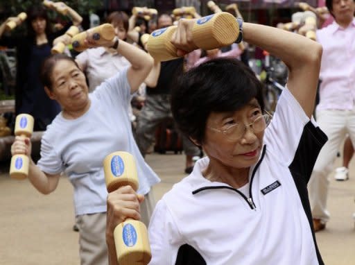 Elderly people work out with wooden dumb-bells in the grounds of a temple in Tokyo on Respect-for-the-Aged-Day in 2010. The estimated number of elderly aged 80 or older has topped the 8 million mark in Japan