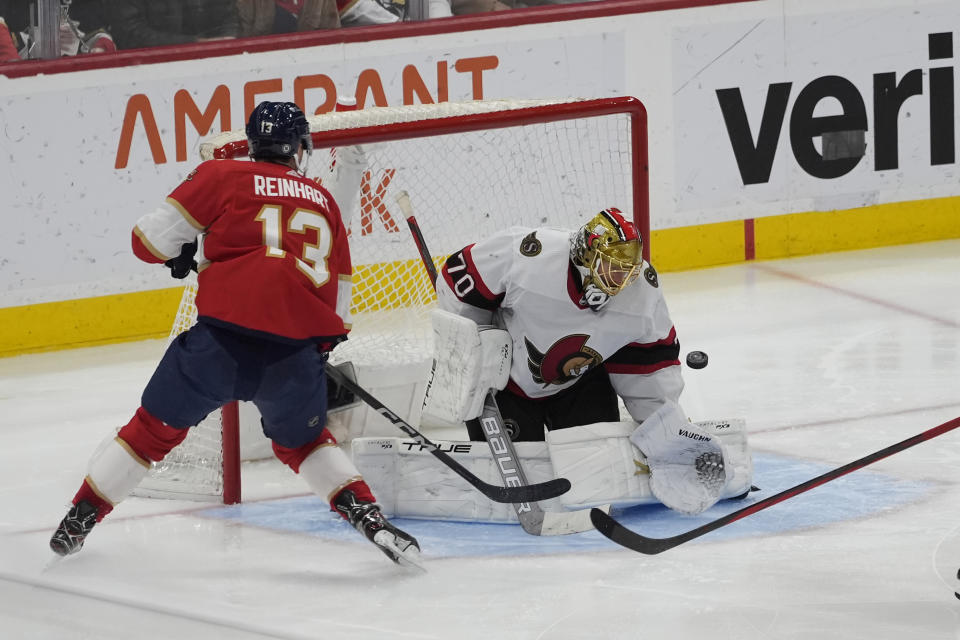 Ottawa Senators goaltender Joonas Korpisalo (70) stops a shot on goal by Florida Panthers center Sam Reinhart (13) during the third period of an NHL hockey game, Tuesday, April 9, 2024, in Sunrise, Fla. (AP Photo/Marta Lavandier)