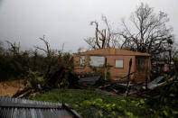 A damaged house is seen after the area was hit by Hurricane Maria in Guayama, Puerto Rico September 20, 2017. REUTERS/Carlos Garcia Rawlins