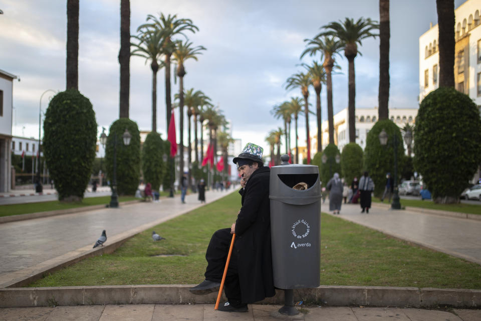 Belhussein Abdelsalam, a Charlie Chaplin impersonator performs in a main avenue in Rabat, Morocco, Thursday, Dec. 17, 2020. When 58-year-old Moroccan Belhussein Abdelsalam was arrested and lost his job three decades ago, he saw Charlie Chaplin on television and in that moment decided upon a new career: impersonating the British actor and silent movie maker remembered for his Little Tramp character. (AP Photo/Mosa'ab Elshamy)