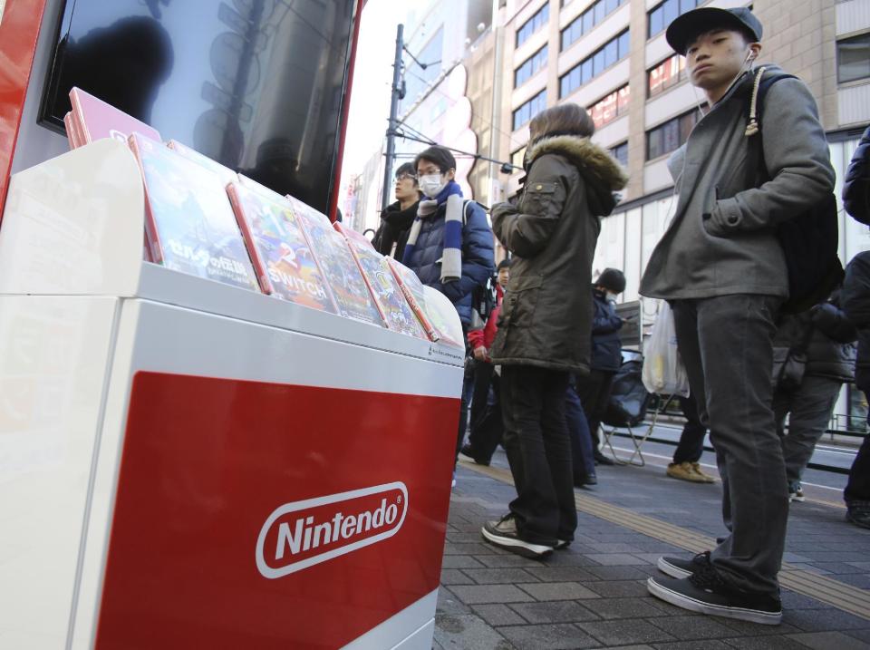 Shoppers line up outside of retail store Bic Camera to buy Nintendo's newest computer game "Switch" in central Tokyo, Friday, March 3, 2017. (AP Photo/Koji Sasahara)