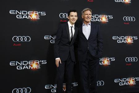 Cast members Asa Butterfield (L) and Harrison Ford pose at the premiere of "Ender's Game" at the TCL Chinese theatre in Hollywood, California October 28, 2013. REUTERS/Mario Anzuoni