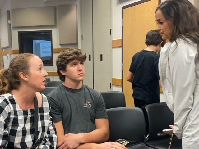 Shawna Mannon, with her son Carter, speaks with Valentina Gaylor, who attended Wednesday night's Lake Travis school board meeting to lend support. Carter Mannon, who's severely allergic to peanuts, was exposed to peanuts by teammates on purpose in October, his mother said. Shawna Mannon implored the district to take further action against those teammates.