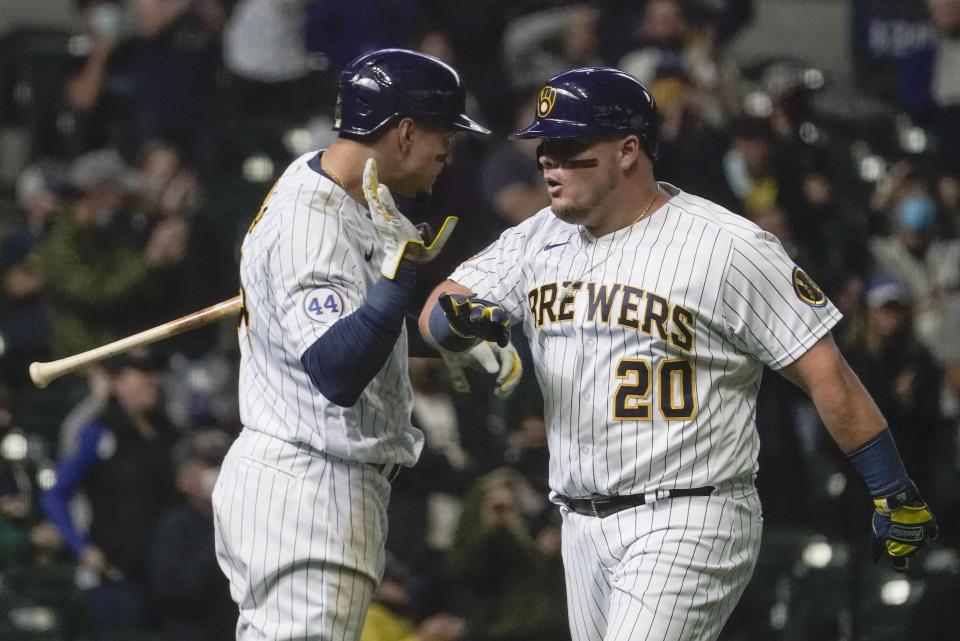 Milwaukee Brewers' Daniel Vogelbach is congratulated by Avisail Garcia after hitting a two-run home run during the seventh inning of a baseball game against the Pittsburgh Pirates Sunday, April 18, 2021, in Milwaukee. (AP Photo/Morry Gash)