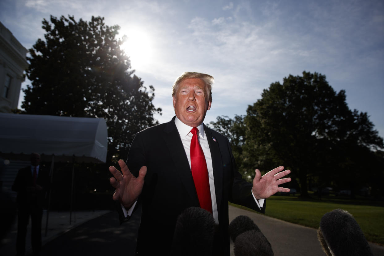 President Trump talks with reporters on the South Lawn of the White House in Washington, D.C., Thursday. (AP Photo/Evan Vucci)   