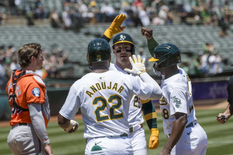 Oakland Athletics' Brent Rooker, center, is congratulated by Miguel Andujar (22) and Daz Cameron after hitting a three-run home-run against the Baltimore Orioles during the first inning of a baseball game Saturday, July 6, 2024, in Oakland, Calif. (AP Photo/John Hefti)