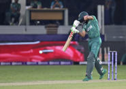 Pakistan's cricket captain Babar Azam hits a boundary during the Cricket Twenty20 World Cup match between India and Pakistan in Dubai, UAE, Sunday, Oct. 24, 2021. (AP Photo/Aijaz Rahi)