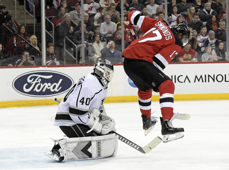 Los Angeles Kings goaltender Calvin Petersen (40) gloves the puck as he is screened by New Jersey Devils right wing Wayne Simmonds (17) during the second period of an NHL hockey game Saturday, Feb. 8, 2020, in Newark, N.J. (AP Photo/Bill Kostroun)