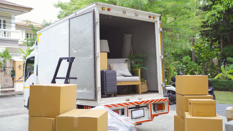 A moving truck with boxes and people's belongings