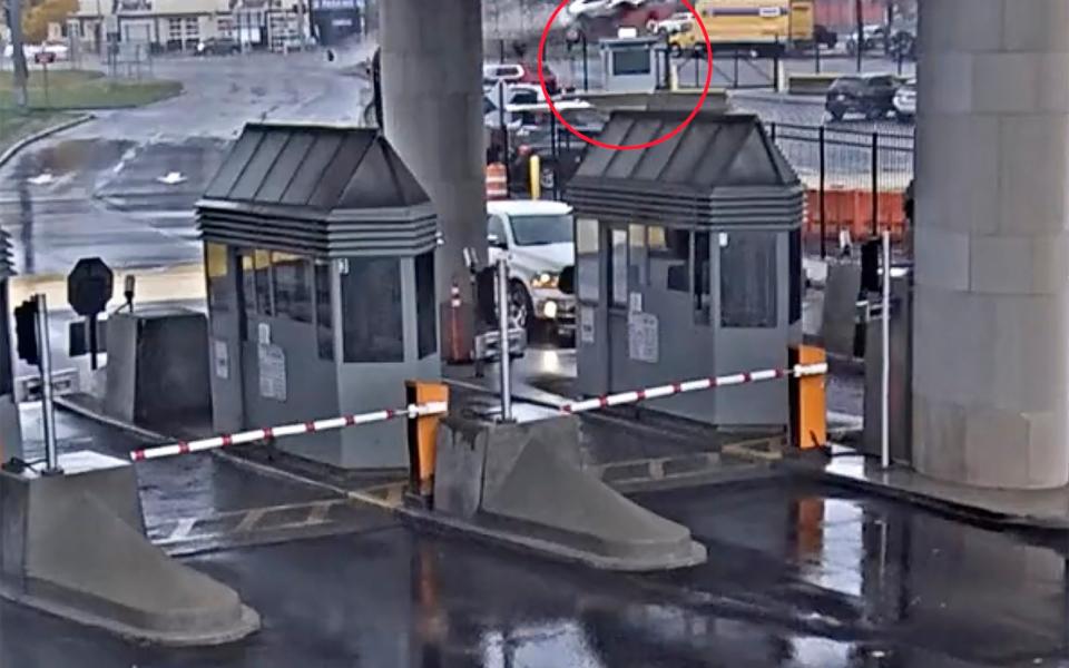In this image taken from security video, a light colored vehicle, top center, flies over a fence into the Rainbow Bridge customs plaza