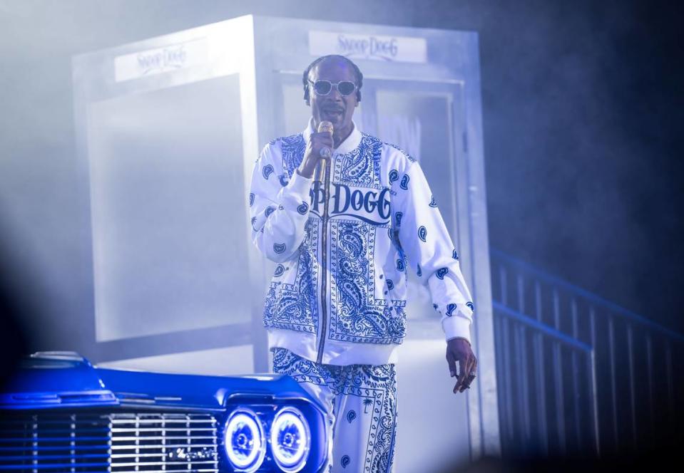 Snoop Dogg raps to Eazy-E’s “Boyz-n-the-Hood” on stage next to a classic car at his High School Reunion Tour stop in Sacramento on Friday, Aug. 25, 2023, at Golden 1 Center. Also performing were Wiz Khalifa, Too $hort, Warren G, Berner and DJ Drama.