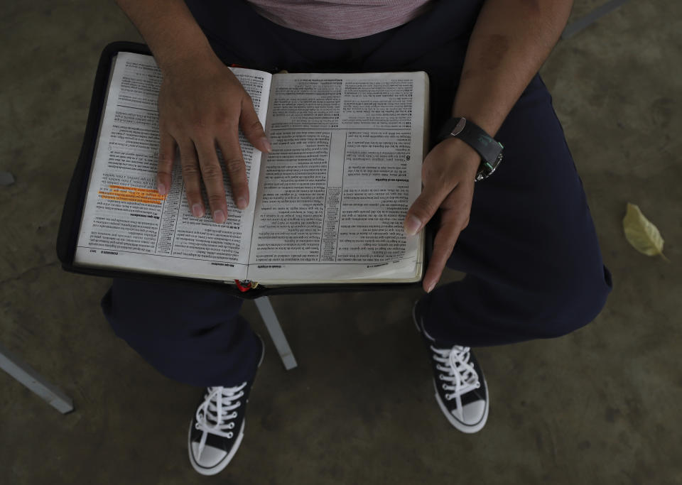 A young man who was imprisoned for belonging to a gang reads a Bible during family visiting hours at the “Vida Libre” or “free life,” rehabilitation center, in Santa Ana, El Salvador, Saturday, April 29, 2023. Vida Libre, a church program founded by American pastor Kenton Moody, takes in minors who are nearing the end of their prison sentence and have demonstrated good conduct. (AP Photo/Salvador Melendez)