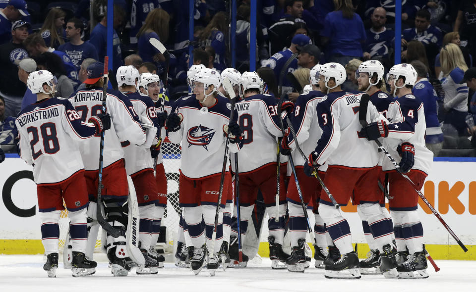 The Columbus Blue Jackets celebrates their 4-3 win over the Tampa Bay Lightning during Game 1 of an NHL Eastern Conference first-round hockey playoff series Wednesday, April 10, 2019, in Tampa, Fla. (AP Photo/Chris O'Meara)