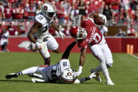 Arkansas running back AJ Green (0) is taken down by Auburn defenders Nehemiah Pritchett (18) and Bydarrius Knighten (19) during the first half of an NCAA college football game Saturday, Oct. 16, 2021, in Fayetteville, Ark. (AP Photo/Michael Woods)