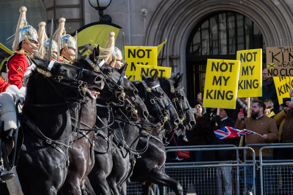 LONDON, UNITED KINGDOM - NOVEMBER 07: Demonstrators hold flags and banners near Parliament as they protest against the monarchy and the Crown ahead of the State Opening of Parliament, which marks the formal start of the parliamentary year on November 07, 2023. King Charles III will travel in a State Procession from Buckingham Palace to the Houses of Parliament to deliver his first King's Speech as monarch, outlining the government's proposed policies and legislation for the coming session. (Photo by Wiktor Szymanowicz/Anadolu via Getty Images)