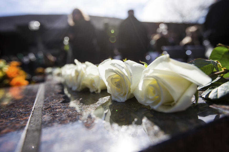 FILE - Roses are placed along the edge of the Memorial Fountain honoring the 75 lives lost in the 1970 plane crash, as Marshall University hosts its 49th annual Memorial Fountain Ceremony on Nov. 14, 2019, in Huntington, W.Va. West Virginia could soon have a new holiday to memorialize 75 people killed in the Marshall University plane crash more than 50 years ago. Democratic Del. Sean Hornbuckle is the lead sponsor of the legislation, which passed the House Government Organization Committee on Monday, Jan. 16, 2023. (Sholten Singer/The Herald-Dispatch via AP, File)