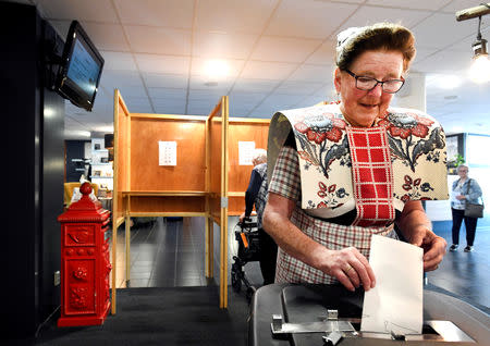 FILE PHOTO: A woman dressed in a traditional costume casts her vote in European Parliament election in Bunschoten-Spakenburg, the Netherlands May 23, 2019. REUTERS/Piroschka van de Wouw/File Photo