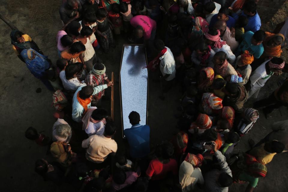 Relatives and villagers gather around the coffin of Balkisun Mandal Khatwe in a village in Nepal on Nov. 23, 2016.