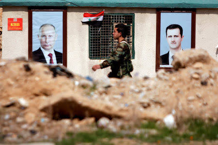 FILE PHOTO: A Syrian soldier loyal to President Bashar al Assad is seen outside eastern Ghouta, in Damascus, Syria February 28, 2018. REUTERS/Omar Sanadiki/File Photo