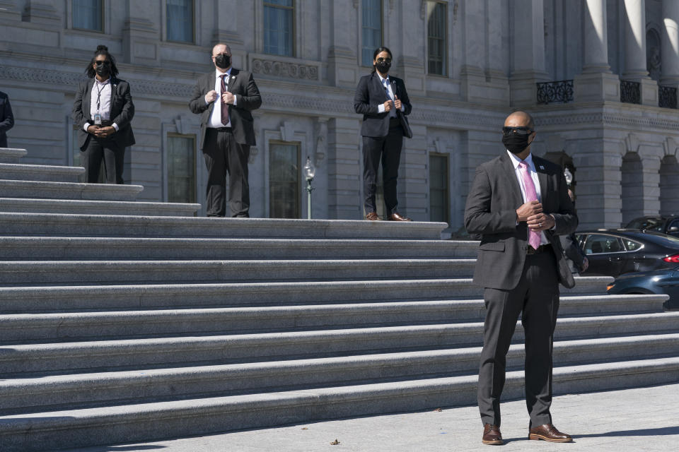 U.S. Capitol Police protective agents stand watch as Speaker of the House Nancy Pelosi, D-Calif., and other lawmakers hold a news event on the steps of the House of Representatives at the Capitol in Washington, Wednesday, March 3, 2021. The Capitol Police said today that they have intelligence showing there is a "possible plot" by a militia group to breach the U.S. Capitol on Thursday. The threat comes nearly two months after thousands of supporters of then-President Donald Trump stormed the Capitol in a violent insurrection as Congress was voting to certify Joe Biden's electoral win. (AP Photo/J. Scott Applewhite)