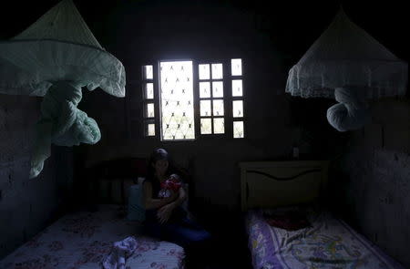 Ianka Mikaelle Barbosa, 18, poses for a photograph with Sophia, 18 days old, who is her second child and was born with microcephaly, at her house in Campina Grande, Brazil February 17, 2016. REUTERS/Ricardo Moraes