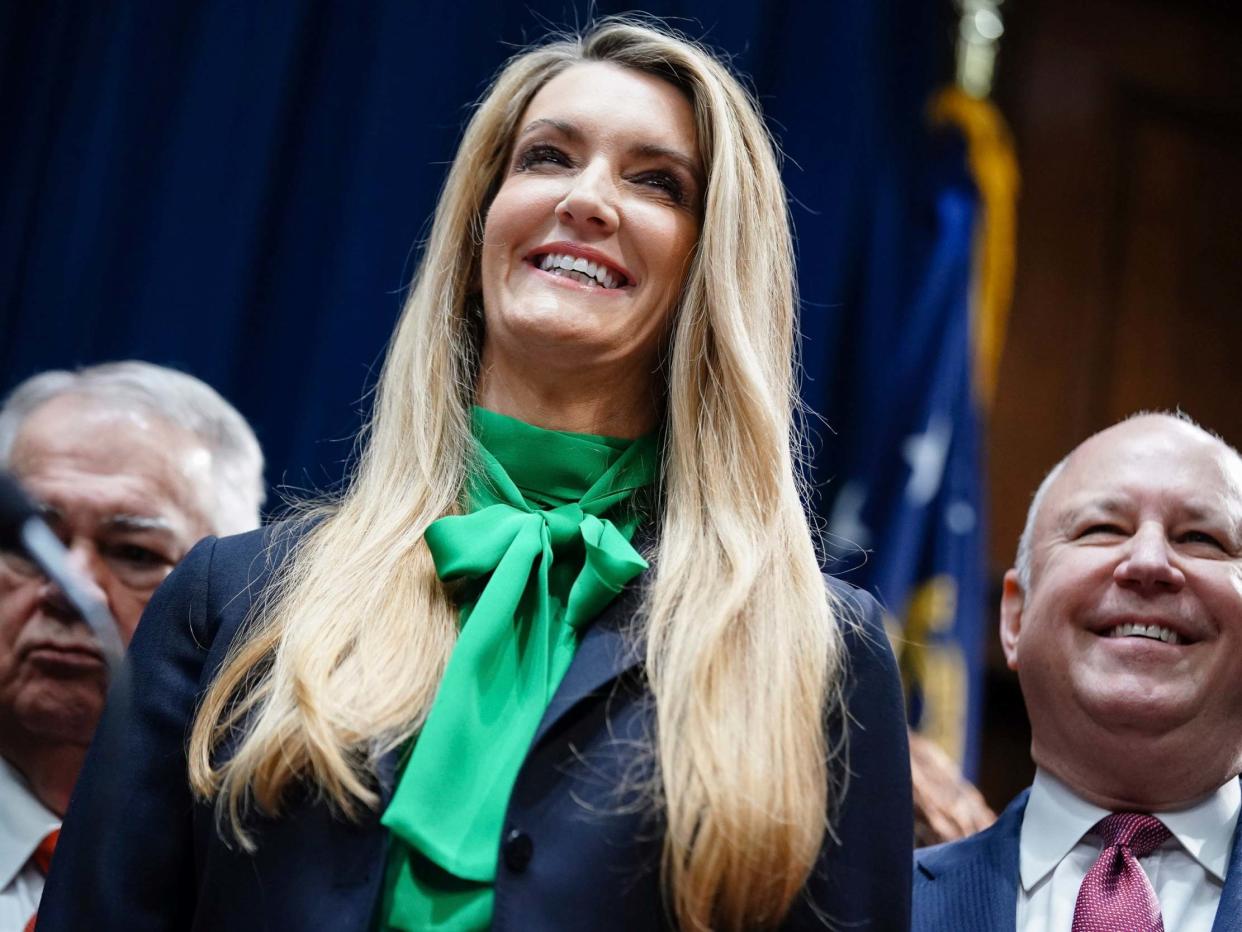 Ms Loeffler smiles while being introduced by governor Kemp: AP