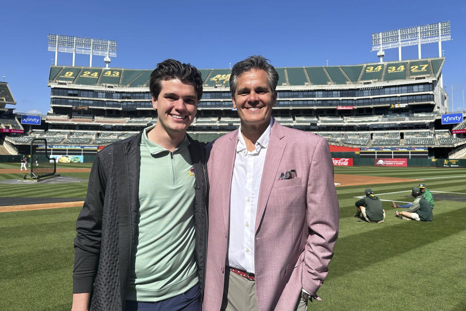 Oakland Athletics broadcaster Chris Caray, left, and his father, Chip, the play-by-play announcer for the St. Louis Cardinals, stand for a photo before the teams' baseball game Monday, April 15, 2024, in Oakland, Calif. (AP Photo/Janie McCauley)