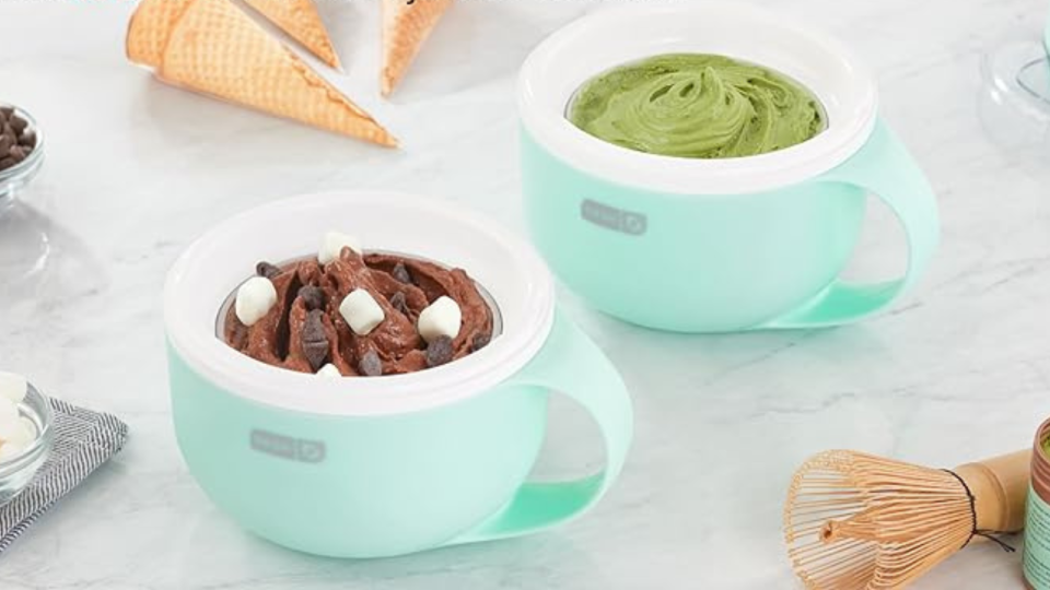 The two ice cream maker mugs on a counter, one filled with chocolate marshmallow ice cream and the other with matcha ice cream