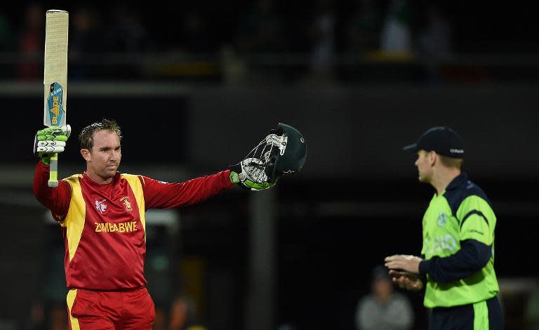 Zimbabwe batsman Brendan Taylor (L) celebrates his century as Ireland captain William Porterfield looks on at the Bellerive Oval in Hobart during a 2015 Cricket World Cup Pool B match on March 7, 2015