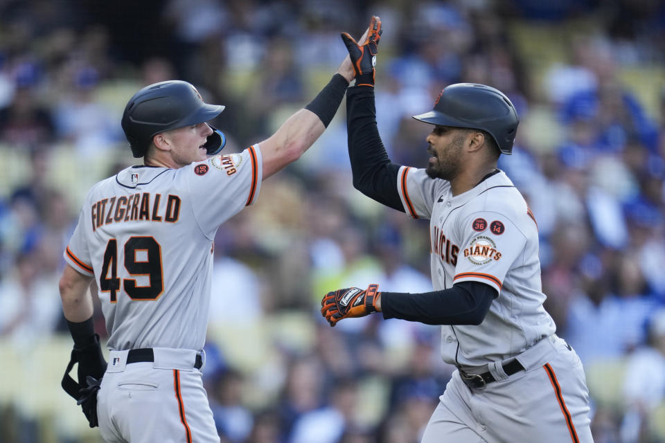 San Francisco Giants' LaMonte Wade Jr., right, celebrates with Tyler Fitzgerald after they both scored off of a home run hit by Wade Jr. during the fifth inning of a baseball game against the Los Angeles Dodgers in Los Angeles, Sunday, Sept. 24, 2023. (AP Photo/Ashley Landis)