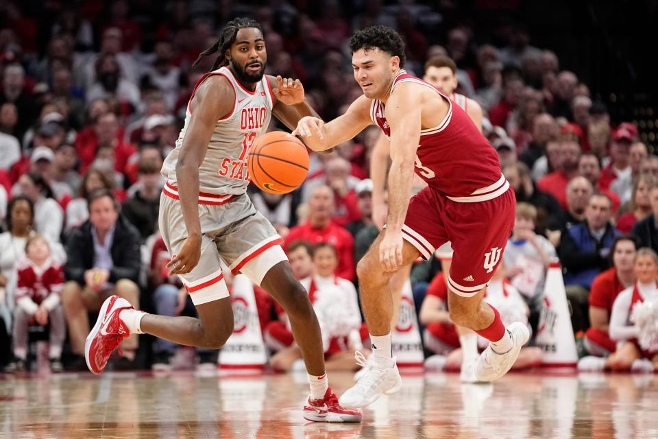 Feb 6, 2024; Columbus, Ohio, USA; Ohio State Buckeyes guard Evan Mahaffey (12) races Indiana Hoosiers guard Anthony Leal (3) to a loose ball during the first half of the menâ€™s basketball game at Value City Arena.