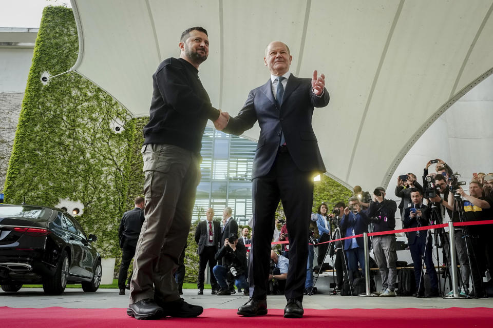 FILE - Ukrainian President Volodymyr Zelenskyy, left, is welcomed by German Chancellor Olaf Scholz at the federal Chancellery, in Berlin, Sunday, May 14, 2023. While the world awaits Ukraine's spring offensive, its leader Volodymyr Zelenskyy has already launched a diplomatic one. In a span of a week, he has dashed to Italy, the Vatican, Germany, France and Britain to shore up support for the defense of his country. On Friday, May 19, 2023, he was in Saudi Arabia to meet with Arab leaders, some of whom are allies with Moscow. (Kay Nietfeld/dpa via AP, File)