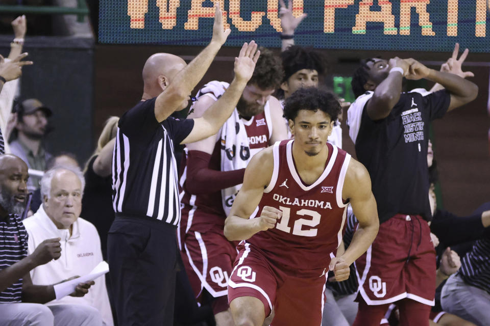 Oklahoma guard Milos Uzan (12) reacts to this 3-point shot against Baylor during the second half of an NCAA college basketball game Wednesday, Feb. 8, 2023, in Waco, Texas. (AP Photo/Rod Aydelotte)